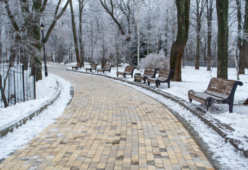 Safe Paw and Safe Thaw deicer on concrete driveway during winter freeze-thaw cycle